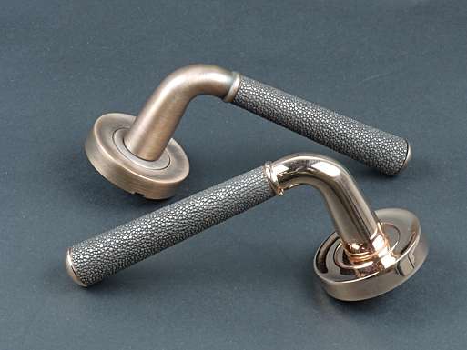 Image of two door levers opposite to one another.