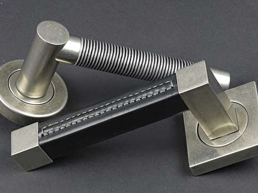 Image displaying two door lever. The wire recess amalfine door lever is positioned behind the square recess leather door lever.