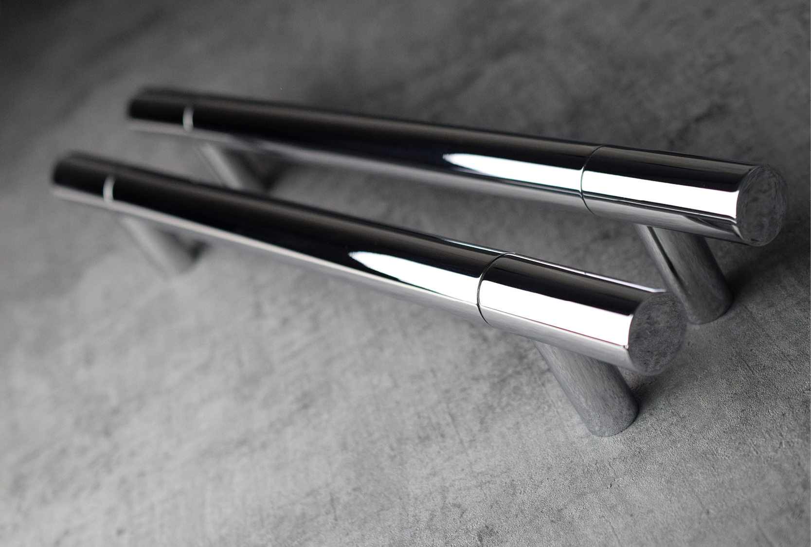 Image of two custom length solid barrel handles. Finished in bright chrome metal finish.