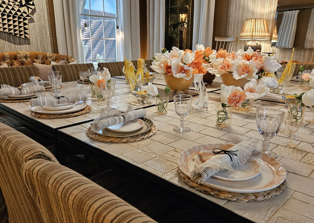 A nude and muted themed dinning room with a large square table set for 6 guests. Exhibited this year at WOW!house in the Design Centre, Chelsea Harbour