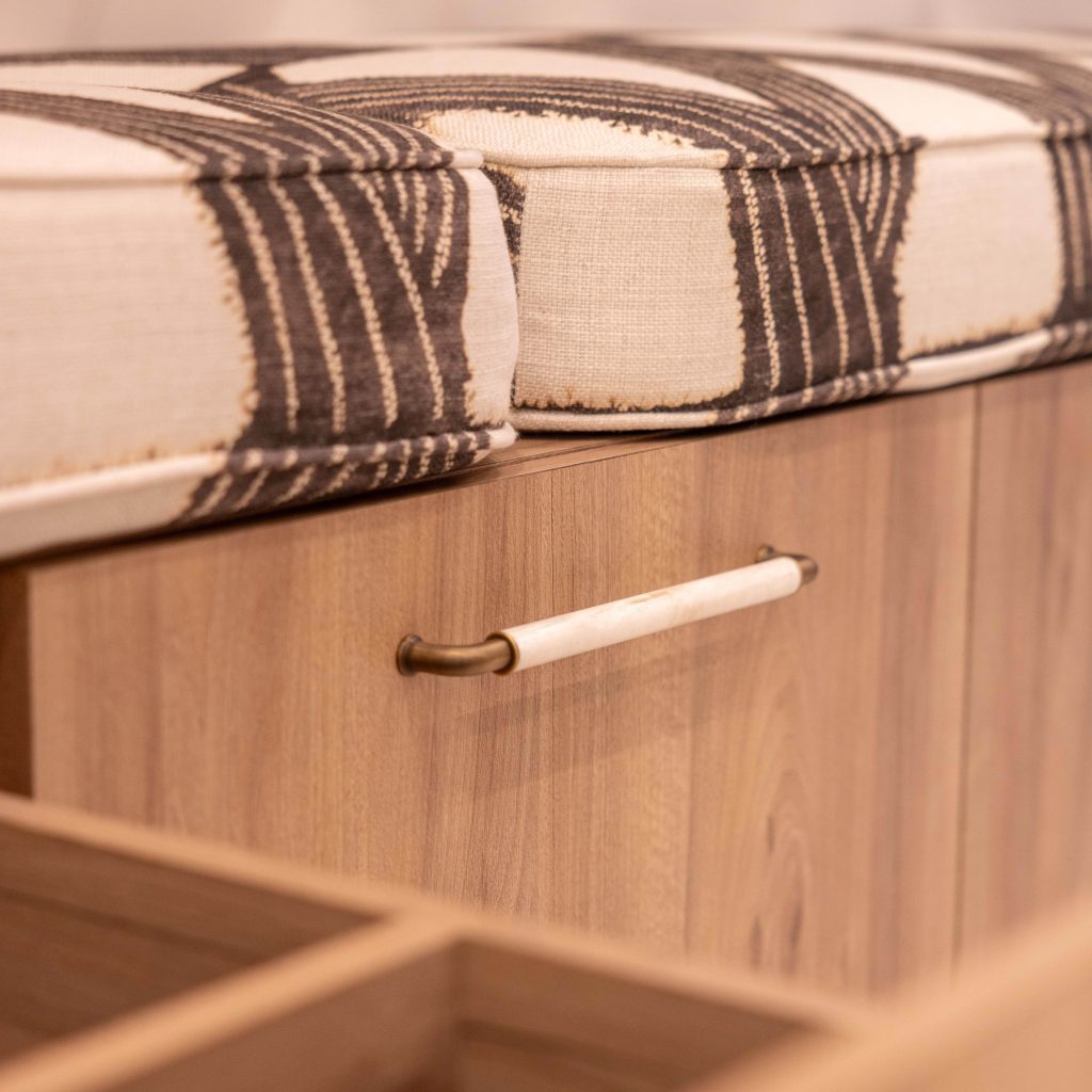 Custom goose neck cabinet pulls for storage drawer in luxury swimwear boutique, Monaco