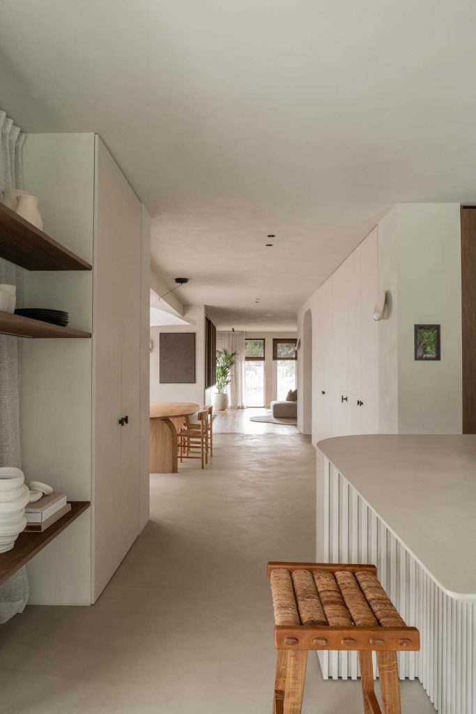A neutral and minimalistic interior style was adopted for this luxury chic family home, featuring natural materials alongside such as stone, wicker seating and micro cement floor.