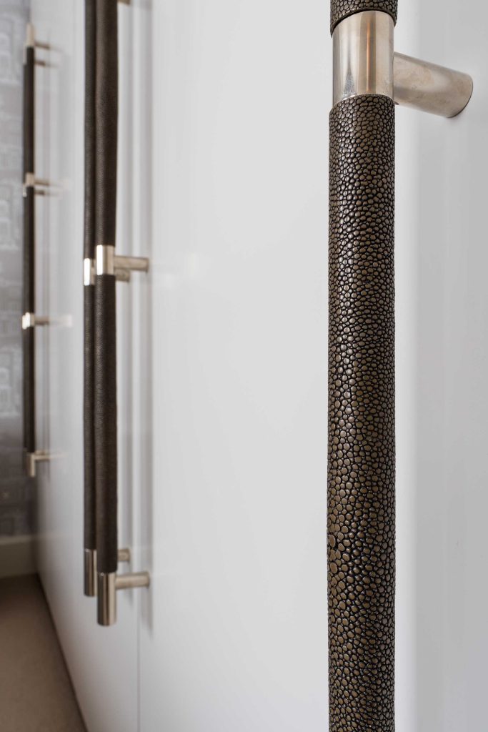 Large multi grip door pulls made by Turnstyle Designs. These pulls are placed on tall cupboard doors in a master bedroom. The textured grips make a bold decorative statement.