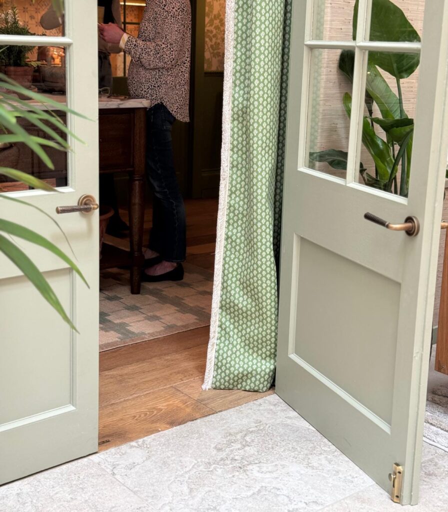Photo shows double doors with one open and two sets of back to back door levers
