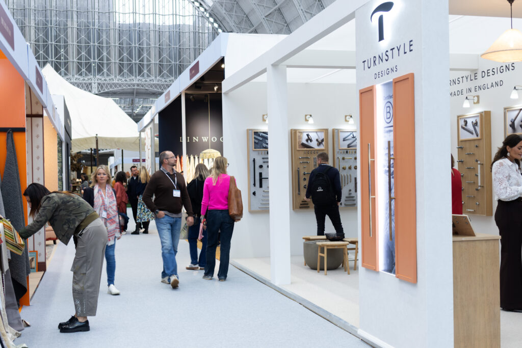 A view of Turnstyle Designs' event stand at Decorex, shot from outside the stand, as delegates pass by.